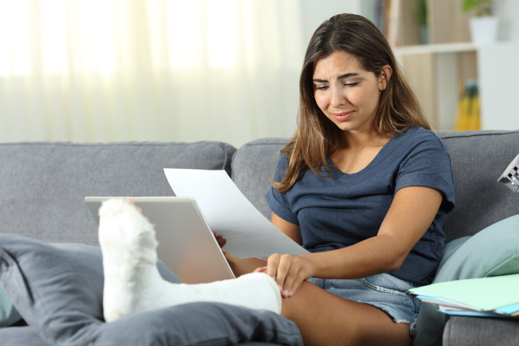 Sad disabled woman working at home