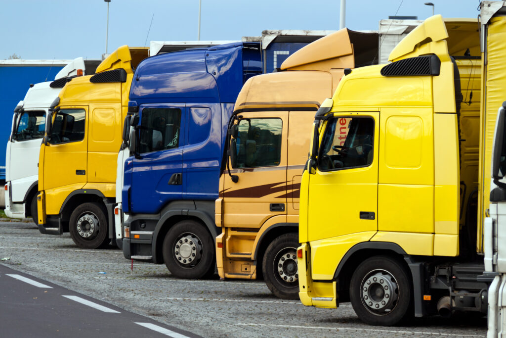Many Related trucks on a highway parking