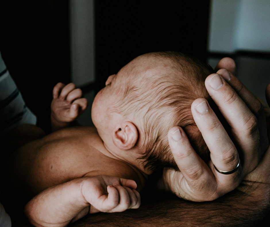 CFCK Law Firm | Atlanta, GA | Blog | Fetal Hypoxia Birth Injury 1 | Up Close of a baby being held by father hands